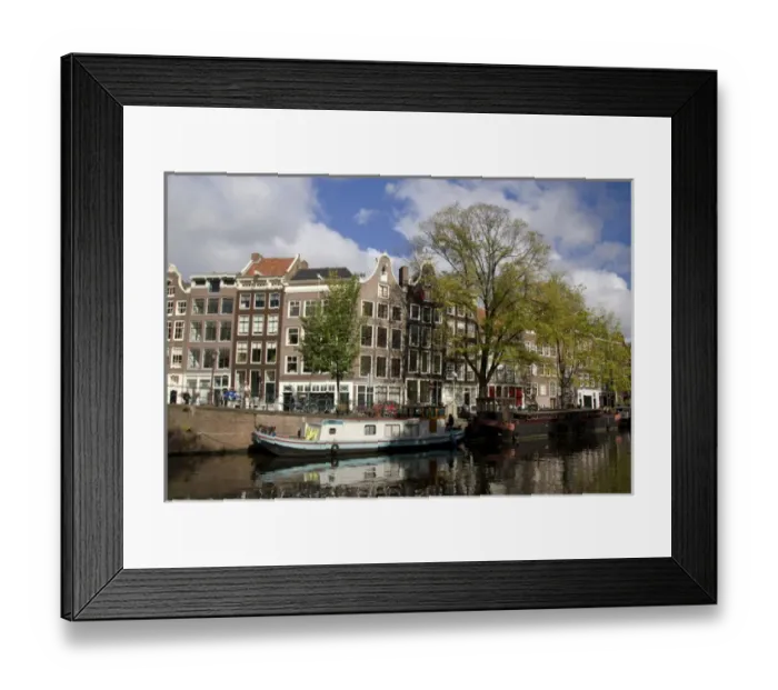 Framed Print : Colorfu buildings line an Amsterdam canal with a houseboat parked out front Framed Print : Colorfu buildings line an Amsterdam canal with a houseboat parked out front