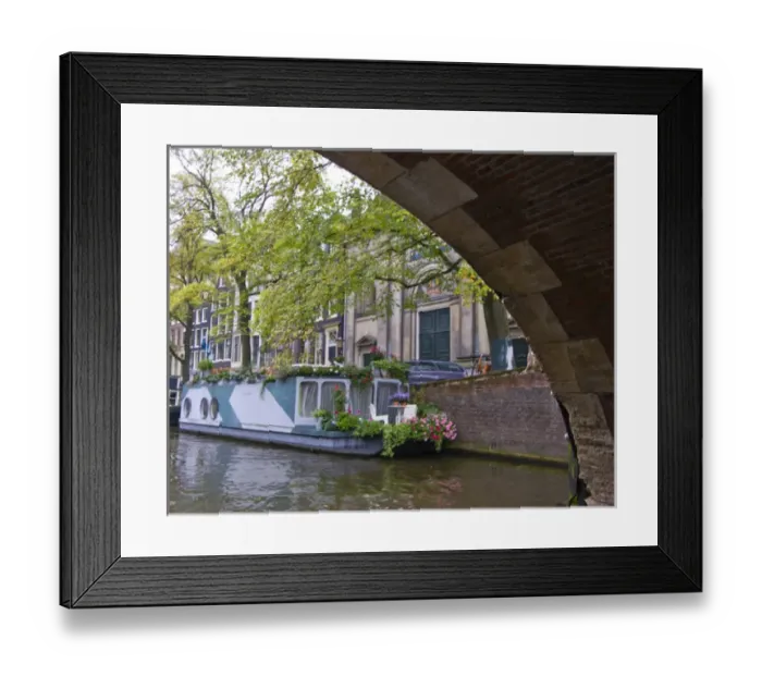 Framed Print : View from under a canal bridge with a colorful houseboat with flowers Framed Print : View from under a canal bridge with a colorful houseboat with flowers