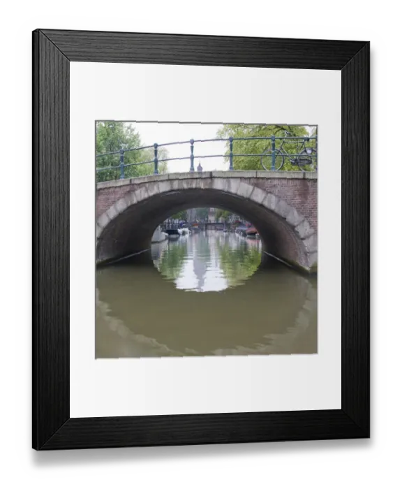 Framed Print : View from under a canal bridge with a circle reflection and a bike on the bridge