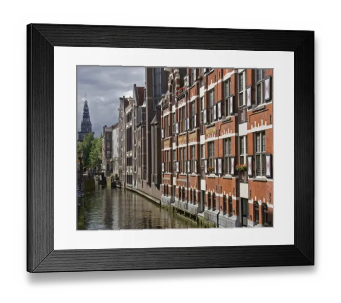 Framed Print : a canal view with colorful buildings and a spire in the distance Framed Print : a canal view with colorful buildings and a spire in the distance