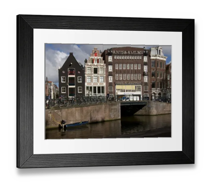 Framed Print : View from the Amstel of many parked bikes and the unique gable buildings