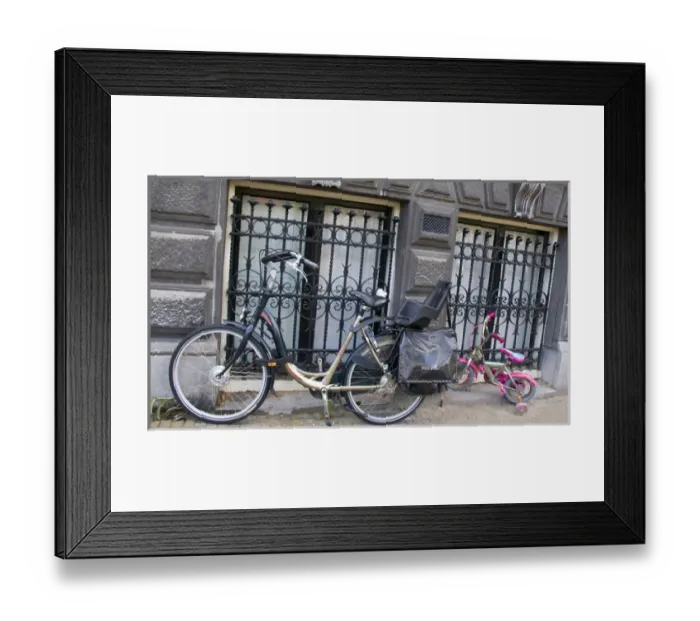 Framed Print : Two parked bikes including a pink child sized bike with Training Wheels Framed Print : Two parked bikes including a pink child sized bike with Training Wheels