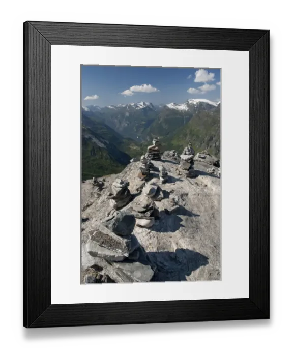 Framed Print : Norway, Geiranger. Travelers stone stacks with a view of the port of Geiranger from Mt