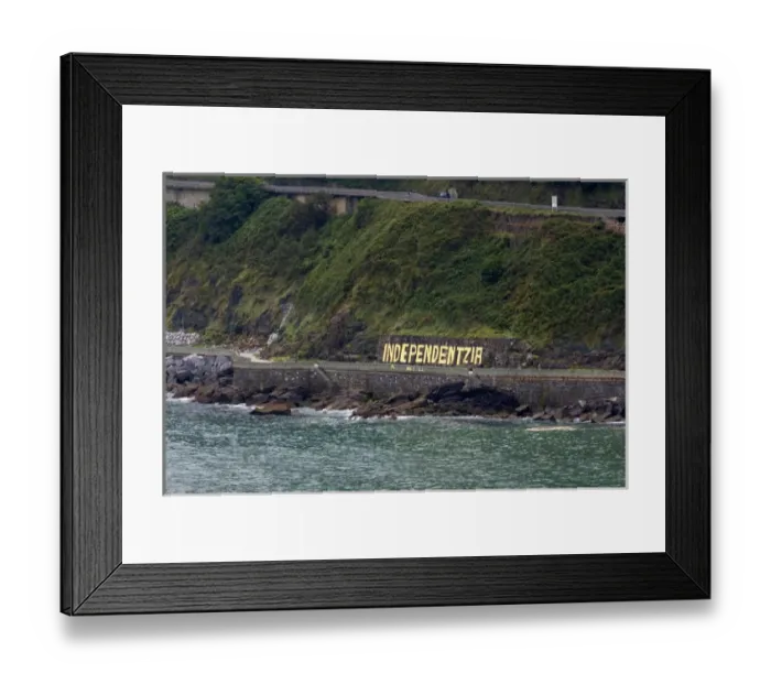 Framed Print : Independentzia painted on a rock wall by Basque separatists across the harbor from Ondarroa