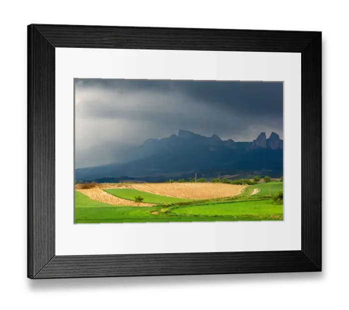 Framed Print : Storm clouds over the Penas Jembrez mountains with a vineyard in the foreground in