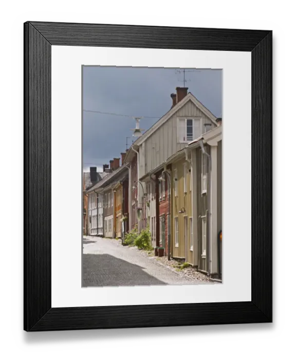 Framed Print : A street scene from the old town where there are many unique old wooden houses. Eksjo town
