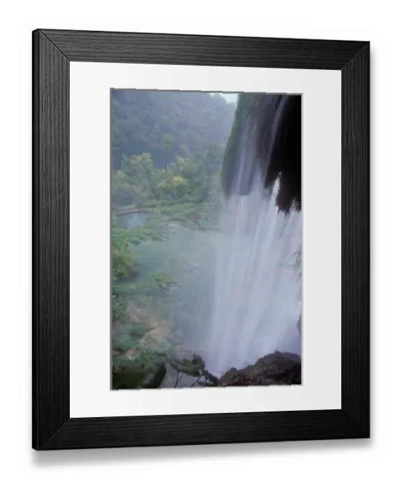 Framed Print : Overlooking the area below from behind a waterfall at Plitvice Lakes National Park Croatia