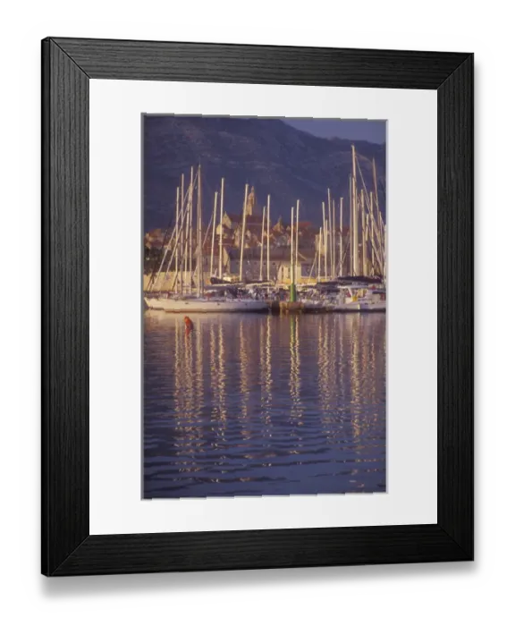 Framed Print : Sailboat masts light up in the early morning light in Korculas Eastern Harbor Framed Print : Sailboat masts light up in the early morning light in Korculas Eastern Harbor