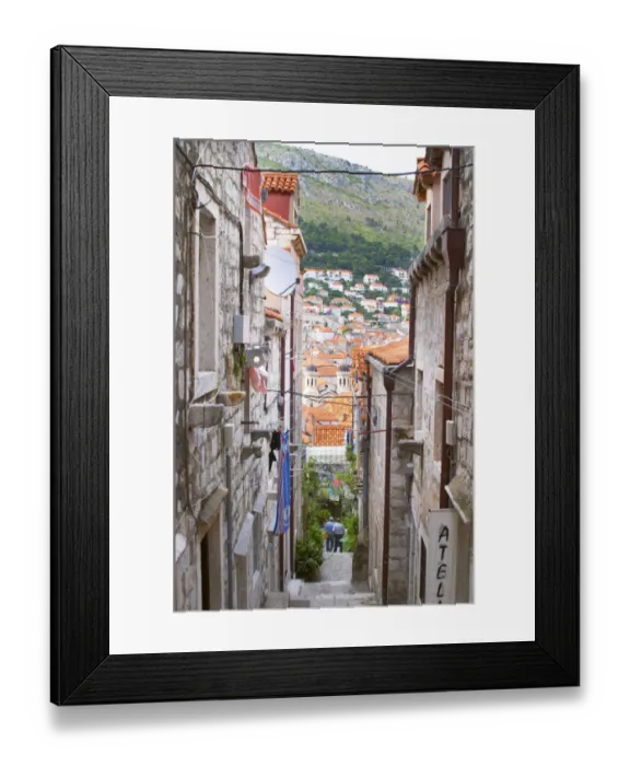 Framed Print : A steep street leading down from the city wall to the city and a view over rooftops Framed Print : A steep street leading down from the city wall to the city and a view over rooftops