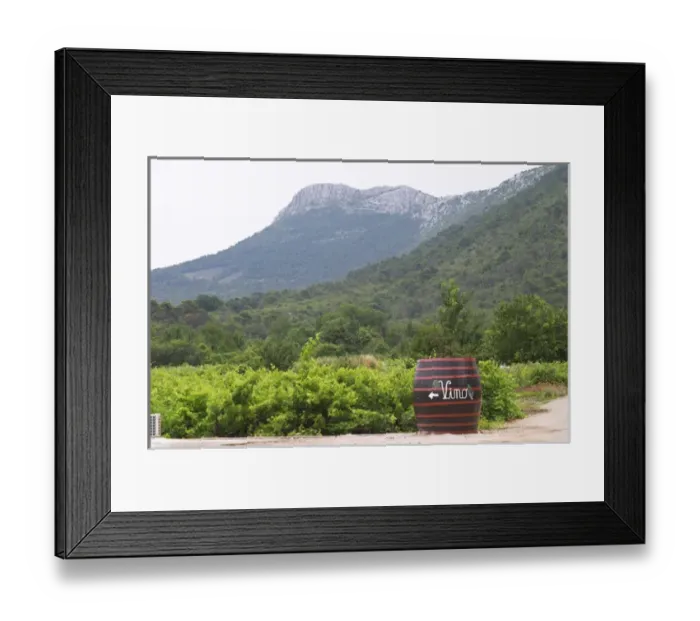 Framed Print : Big barrel standing in the vineyard with writing painted in white saying Vino, grape bunch Framed Print : Big barrel standing in the vineyard with writing painted in white saying Vino, grape bunch