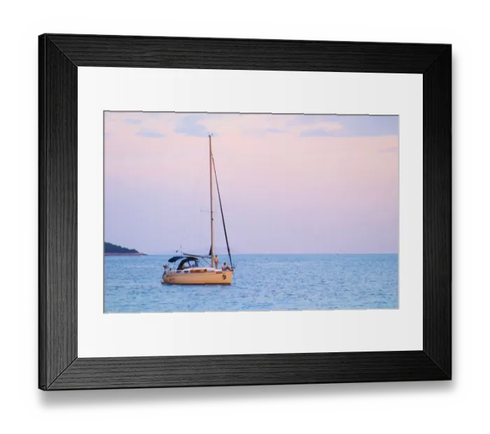 Framed Print : A sailing boat moored in the bay with two people on the deck off Korcula at sunset Framed Print : A sailing boat moored in the bay with two people on the deck off Korcula at sunset