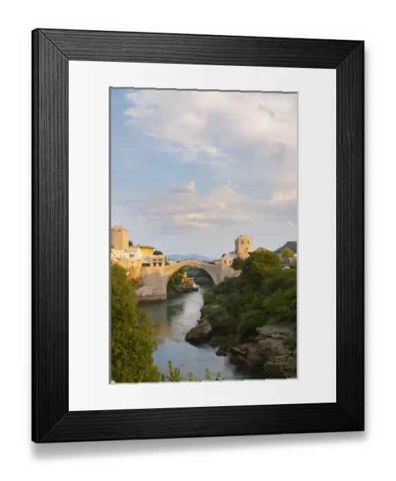 Framed Print : View along the river of the old reconstructed bridge. Sunset late afternoon light