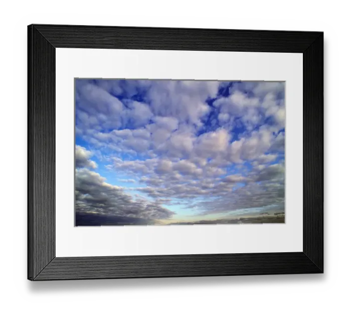 Framed Print : The storm clouds break up to reveal the blue early morning sky above Framed Print : The storm clouds break up to reveal the blue early morning sky above