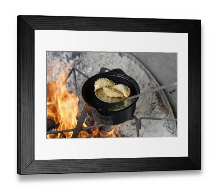 Framed Print : Patagonia Argentina. Empanadas are being cooked in oil; here removed with a colander