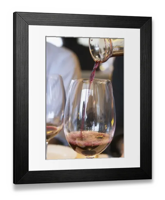 Framed Print : Wine being served in a glass from a decanter. The Restaurant Red at the Hotel Madero Framed Print : Wine being served in a glass from a decanter. The Restaurant Red at the Hotel Madero