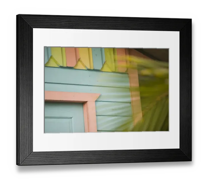 Framed Print : Detail of beach house painted in pastel colors and palm tree, Placencia, Stann Creek District