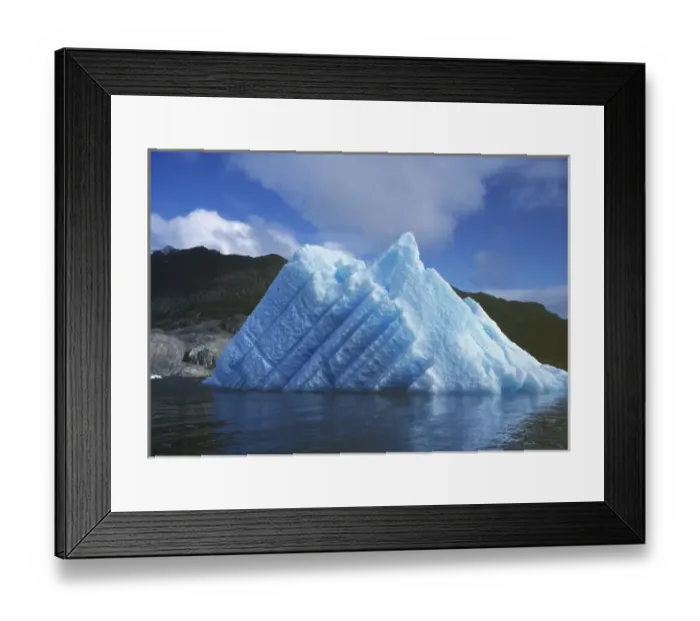 Framed Print : South America, Chile, San Rafael Lagoon NP. A striated, sun-touched iceberg floats Framed Print : South America, Chile, San Rafael Lagoon NP. A striated, sun-touched iceberg floats