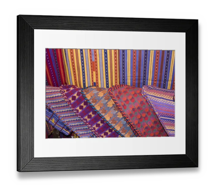 Framed Print : Central America, Guatemala, Antigua. Colorful weavings for sale in shop in Antigua