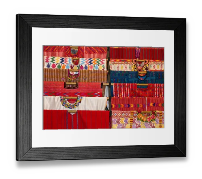 Framed Print : Central America, Guatemala, Antigua. A display of colorful huipils in a shop in Antigua