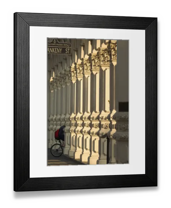 Framed Print : USA, Oregon, Portland, bicyclist riding through columns on Ankeny street Framed Print : USA, Oregon, Portland, bicyclist riding through columns on Ankeny street