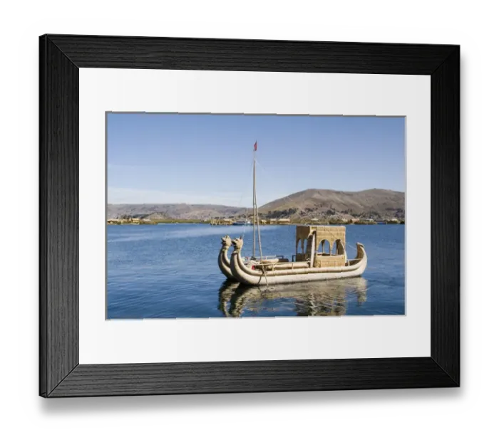 Framed Print : South America - Peru. Reed boat moving through channel along a floating island