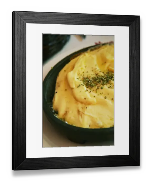 Framed Print : Regional dish of melted cheese on an iron plate with herbs, in the restaurant El Palenque