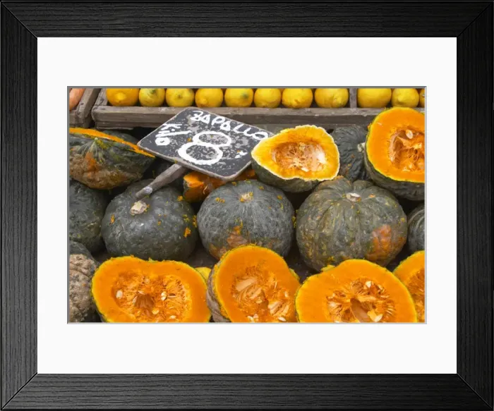 Framed Print : A market stall street market merchant selling pumpkins some cut in half to display