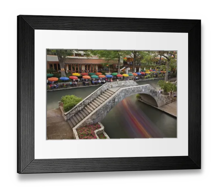 Framed Print : Outdoor cafe along River Walk and boat in motion passing under bridge over San Antonio River