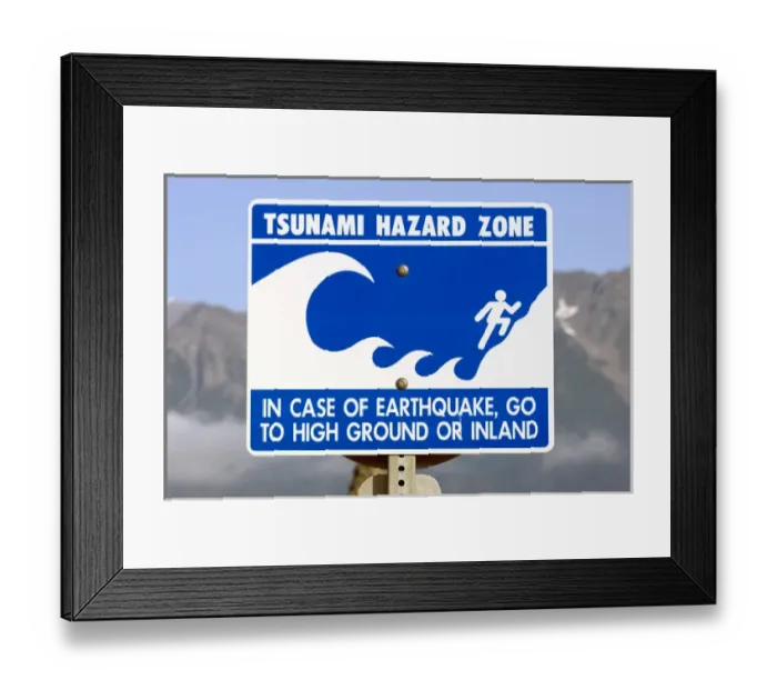 Framed Print : Signs are posted along the streets of Seward Alaska to warn people of possibility of tsunami