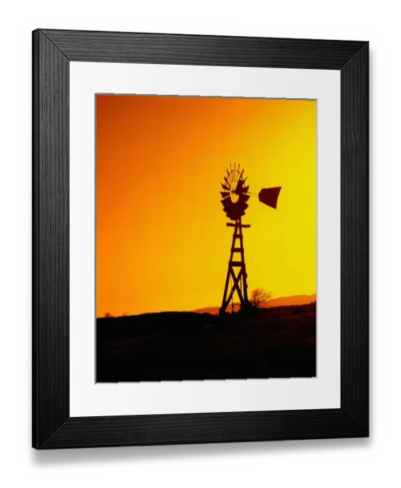 Framed Print : A wooden windmill silhouetted agains the setting sun Framed Print : A wooden windmill silhouetted agains the setting sun