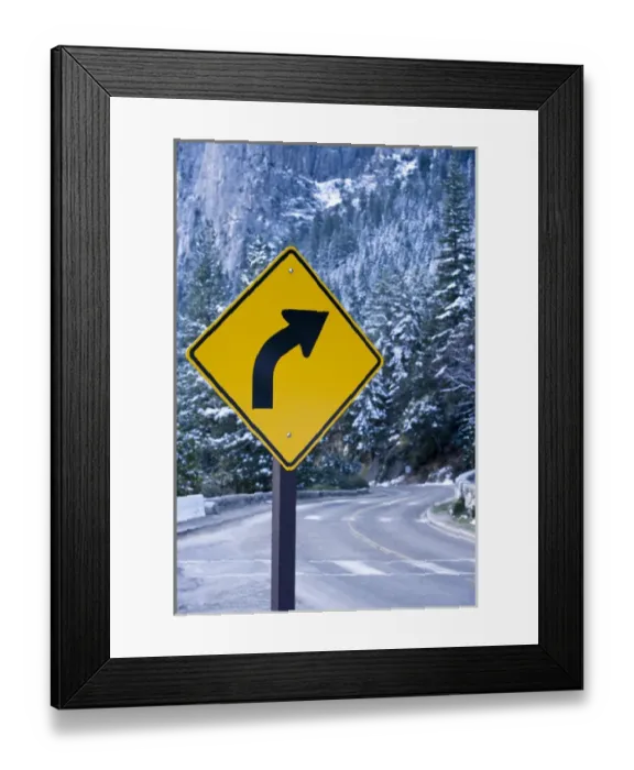 Framed Print : A curve ahead road sign warns visitors entering Yosemite valley on California State Framed Print : A curve ahead road sign warns visitors entering Yosemite valley on California State