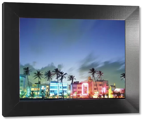 N. A. USA, Florida, Miami, South Beach. Art Deco architecture and palm trees along the strip