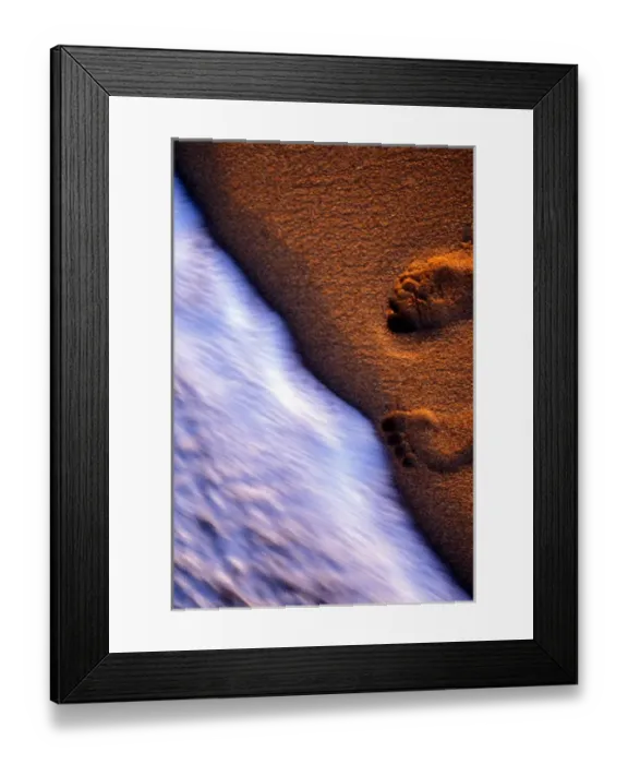 Framed Print : The surf moves in to clear away the the footprints left in the sand by a beachcomber Framed Print : The surf moves in to clear away the the footprints left in the sand by a beachcomber