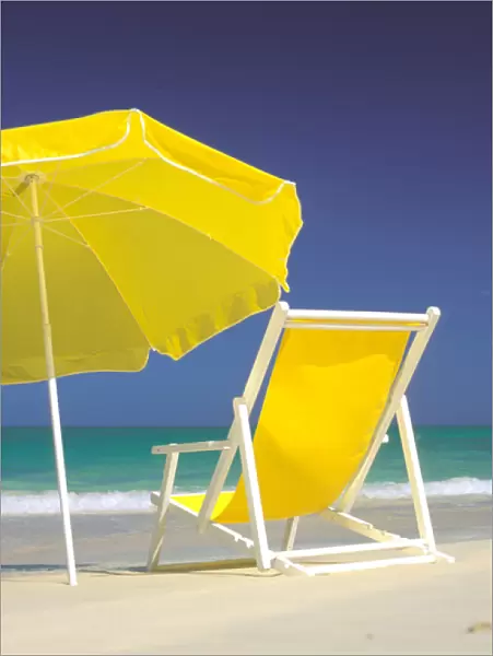USA, Hawaiian Islands. Beach chair and umbrella on beach