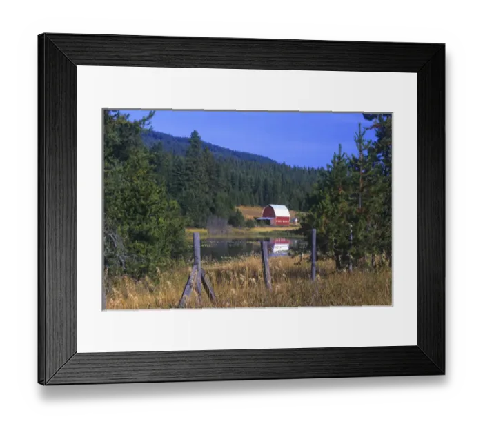 Framed Print : A red barn in relected in a lake near Hayden Lake, Idaho. The old fence in the foreground Framed Print : A red barn in relected in a lake near Hayden Lake, Idaho. The old fence in the foreground