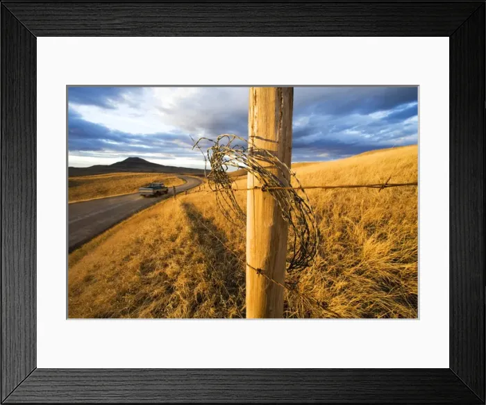 Framed Print : Pickup truck drives by as dramatic light breaks thru remote gravel road Belt Butte Framed Print : Pickup truck drives by as dramatic light breaks thru remote gravel road Belt Butte