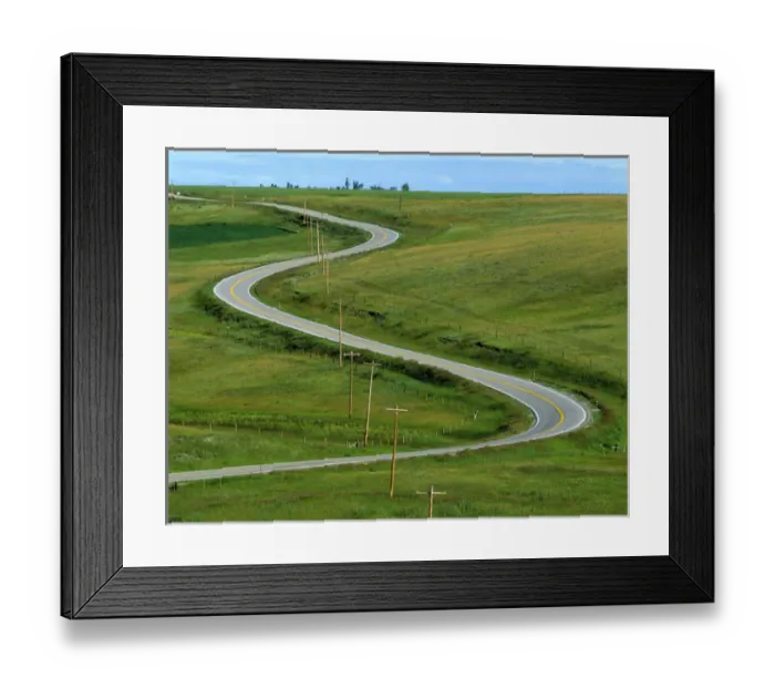 Framed Print : USA, Montana, Browning. A rural righway snakes over the countryside near Browning
