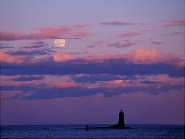 A full moon rises behind Whaleback Lighthouse. New Castle Common, New Castle, NH