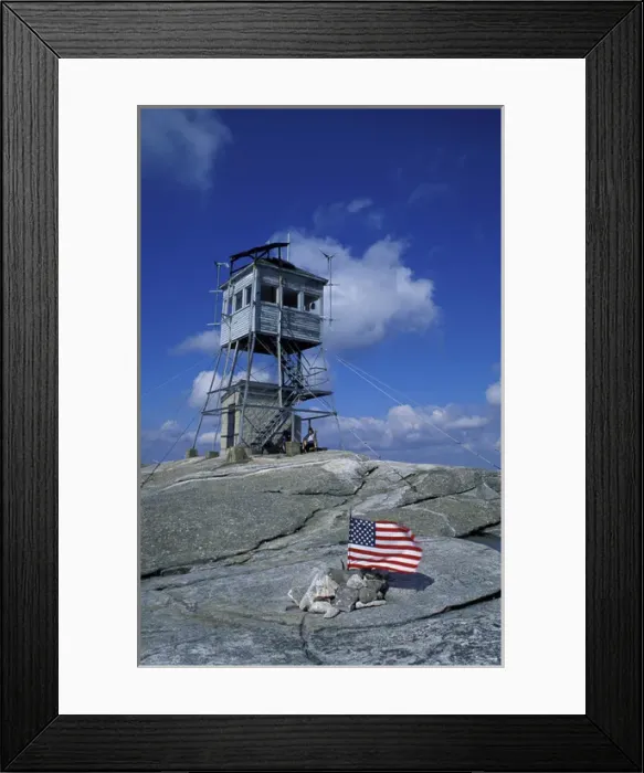 Framed Print : The fire tower on the summit of Mt. Cardigan in Mt. Cardigan State Park. American flag Framed Print : The fire tower on the summit of Mt. Cardigan in Mt. Cardigan State Park. American flag