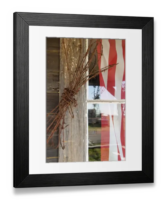 Framed Print : USA, Oregon, Shaniko. Flag in window next to coil of barbed wire. Credit as: Nancy