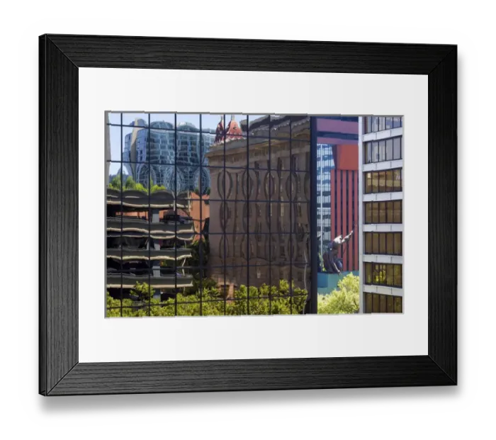 Framed Print : Portlandia sculpture seen between buildings reflected in buildings in downtown Portland Framed Print : Portlandia sculpture seen between buildings reflected in buildings in downtown Portland