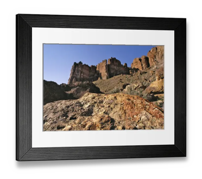 Framed Print : USA, Oregon, John Day Fossil Beds NM. The Clarno Palisades tower above the rocks