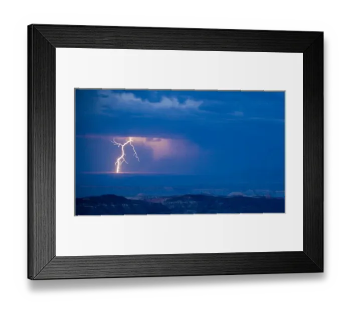 Framed Print : A bolt of lightning strikes the Utah desert as a rain storm moves across the landscape Framed Print : A bolt of lightning strikes the Utah desert as a rain storm moves across the landscape