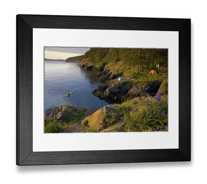 Framed Print : USA, Washington State, San Juan Islands. Man at kayak camp with another man paddling