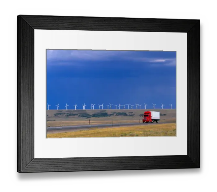 Framed Print : A truck traveling on the highway with a row of windmills in the background in Arlington Framed Print : A truck traveling on the highway with a row of windmills in the background in Arlington