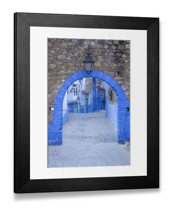 Framed Print : Morocco, Chefchaouen. A blue arch and quiet street entering the medina of the village Framed Print : Morocco, Chefchaouen. A blue arch and quiet street entering the medina of the village