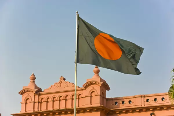 Flag of Bangladesh before the pink coloured Ahsan Manzil palace in Dhaka, Bangladesh