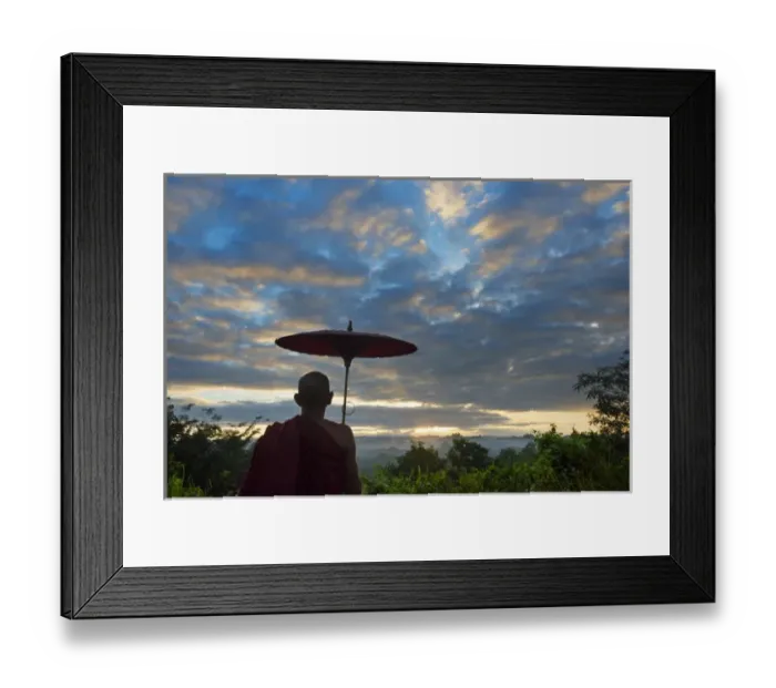 Framed Print : Monk with umbrella watching ancient temple and pagoda in the jungle at sunrise, Mrauk-U