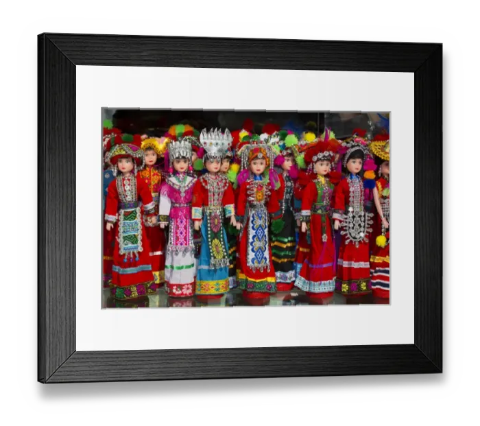 Framed Print : Dolls on display in Ethnic Native Dress, Kunming Ethnic Minorities Villiage Park, China