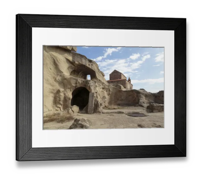Framed Print : Georgia, Uplistsikhe. A room carved into a cliff face, with a church in the background Framed Print : Georgia, Uplistsikhe. A room carved into a cliff face, with a church in the background